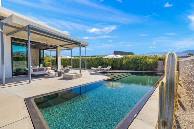 view of pool featuring a patio area and a fire pit