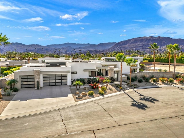 view of front of home with a garage and a mountain view