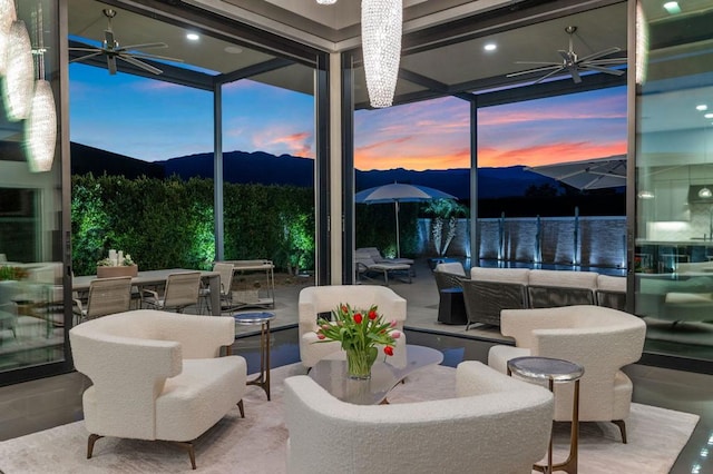 interior space featuring a mountain view, an outdoor living space, and ceiling fan