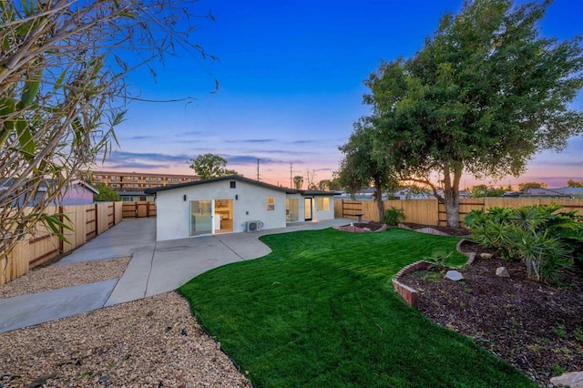 yard at dusk with a patio area