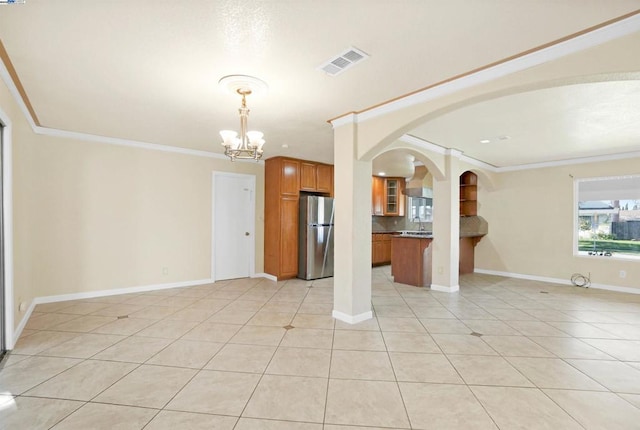 unfurnished living room featuring a notable chandelier, ornamental molding, light tile patterned floors, and sink