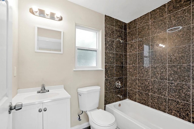 full bathroom with toilet, tiled shower / bath, and vanity