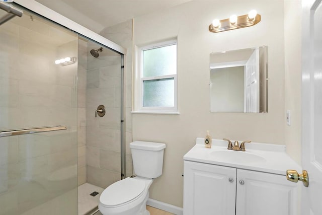 bathroom with vanity, toilet, and walk in shower