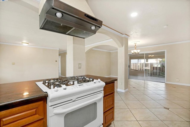 kitchen with range hood, light tile patterned floors, gas range gas stove, and ornamental molding