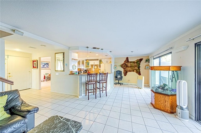 kitchen with decorative light fixtures, light tile patterned floors, a kitchen bar, and crown molding