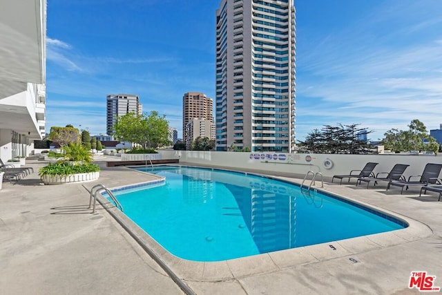 view of swimming pool featuring a patio area