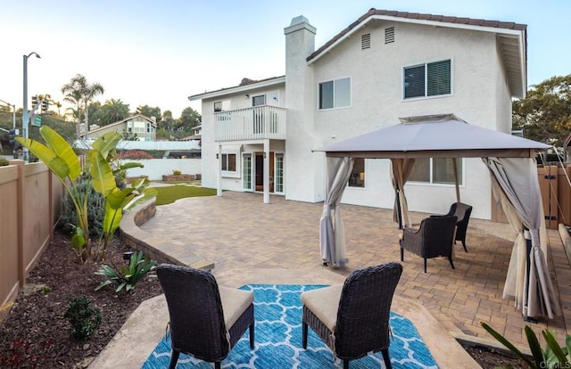 back of house featuring a gazebo, a patio area, and a balcony