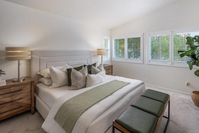 carpeted bedroom with vaulted ceiling