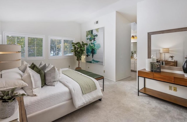 carpeted bedroom featuring connected bathroom