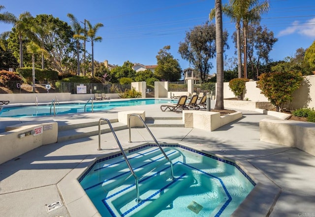 view of pool with a patio and a community hot tub