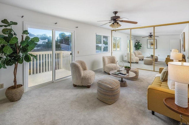 carpeted living room featuring ceiling fan