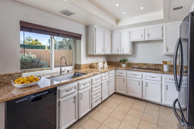 kitchen with black appliances, white cabinets, sink, and a tray ceiling