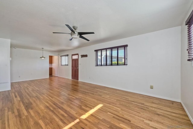 spare room featuring light hardwood / wood-style floors and ceiling fan