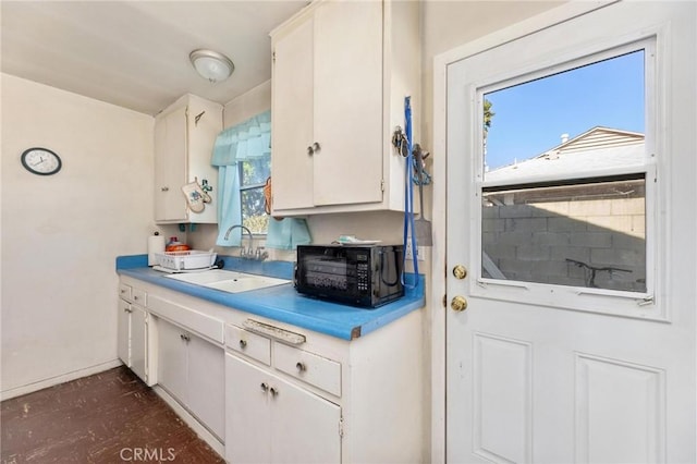 kitchen featuring sink, white cabinetry, and a healthy amount of sunlight