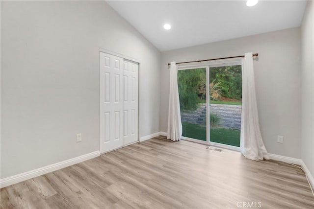 spare room with light wood-style flooring, baseboards, lofted ceiling, and recessed lighting