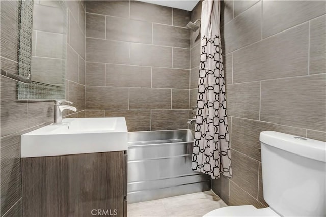 bathroom with toilet, vanity, tile walls, and walk in shower