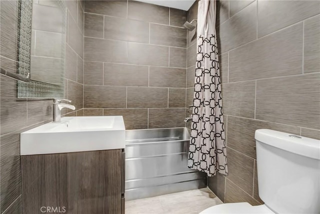 bathroom with shower / bath combo, vanity, tile walls, and toilet