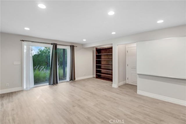 interior space featuring recessed lighting, light wood-style flooring, and baseboards