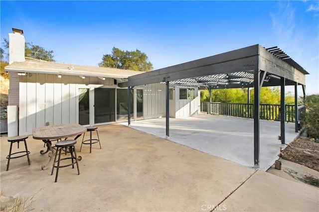 view of patio / terrace featuring a pergola and a carport
