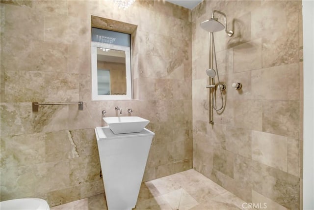 bathroom with vanity and a tile shower