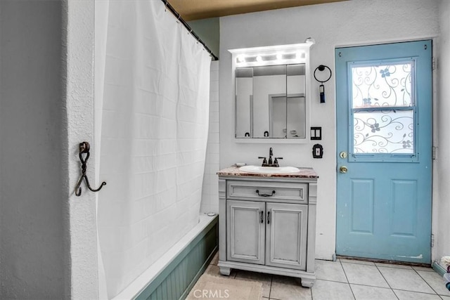 bathroom featuring shower / bath combination with curtain, vanity, and tile patterned flooring