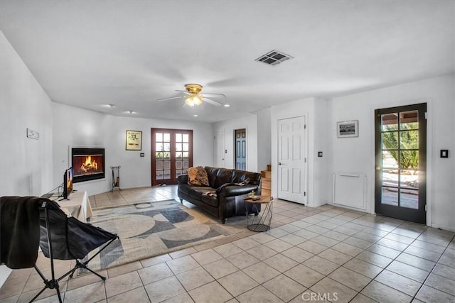 living room with ceiling fan, light tile patterned floors, and french doors