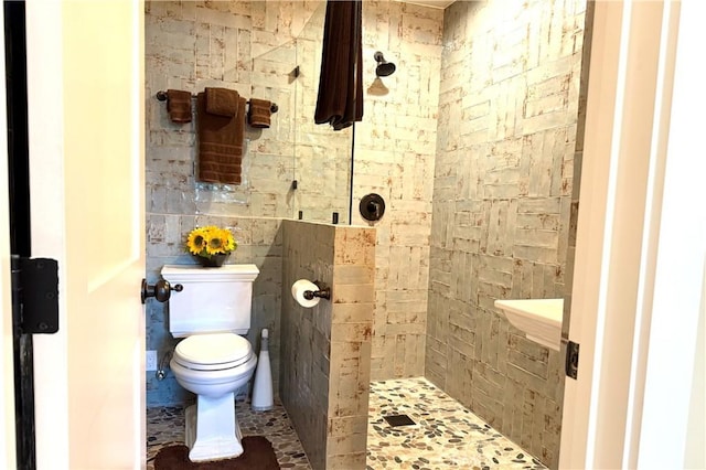 full bathroom featuring toilet and a stall shower