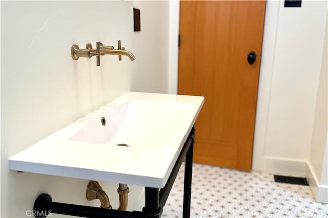 bathroom with a sink and visible vents