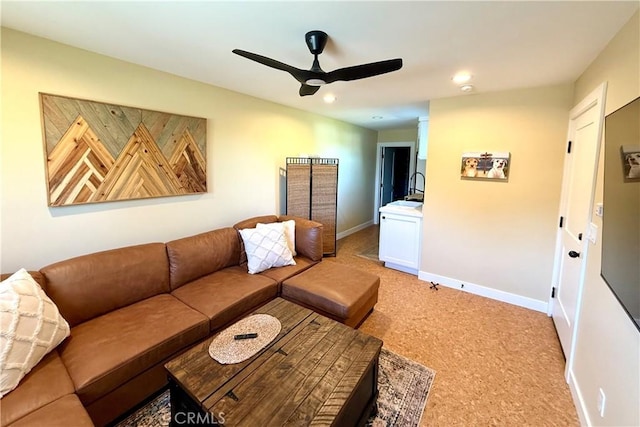 living area with recessed lighting, baseboards, a ceiling fan, and light colored carpet