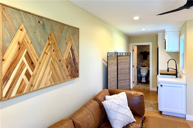 living area with a ceiling fan and recessed lighting