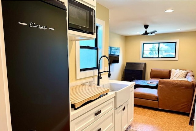 interior space with ceiling fan, a sink, and recessed lighting