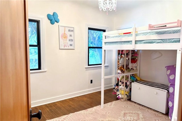 bedroom featuring baseboards and wood finished floors