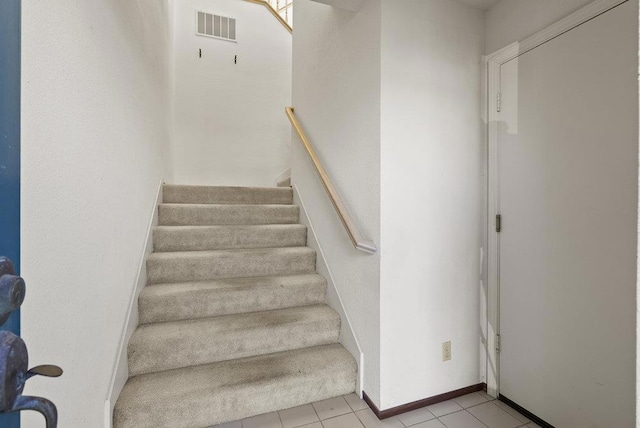 stairs with tile patterned flooring