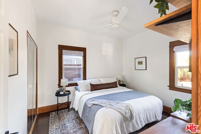 bedroom featuring ceiling fan and dark wood-type flooring