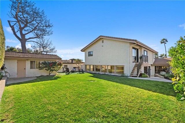 rear view of house with a yard