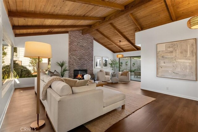 living room with a brick fireplace, hardwood / wood-style floors, beam ceiling, and wood ceiling