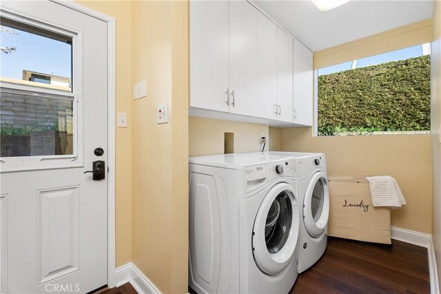 laundry area with dark wood-type flooring, cabinets, and independent washer and dryer