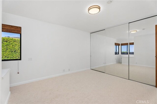 unfurnished bedroom featuring a closet and carpet floors