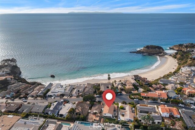 bird's eye view with a water view and a beach view