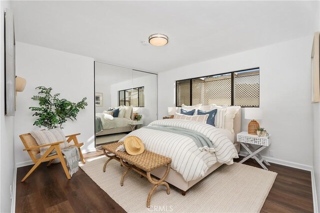 bedroom with dark wood-type flooring