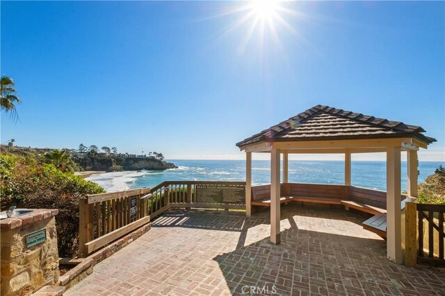 view of patio / terrace with a gazebo and a water view