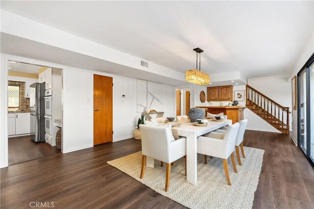 dining area featuring dark wood-type flooring