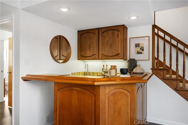 kitchen with dark wood-type flooring and kitchen peninsula