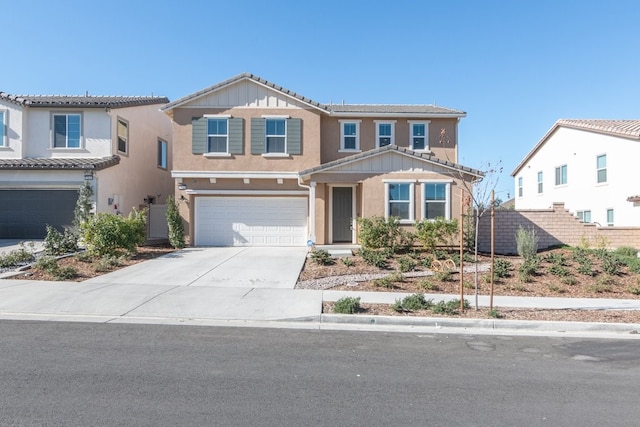 view of front facade featuring driveway, an attached garage, and stucco siding