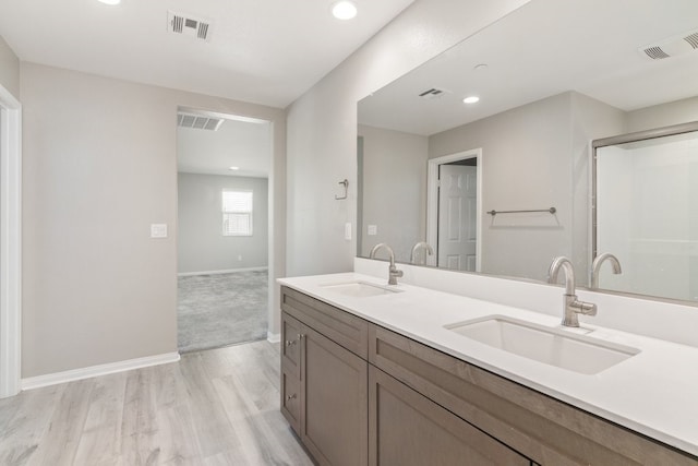 bathroom featuring hardwood / wood-style flooring and vanity