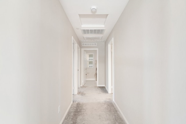 hallway with light colored carpet