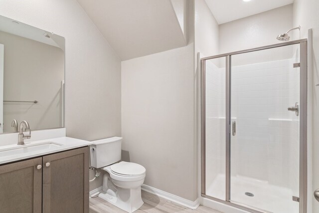 bathroom featuring toilet, walk in shower, wood-type flooring, and vanity