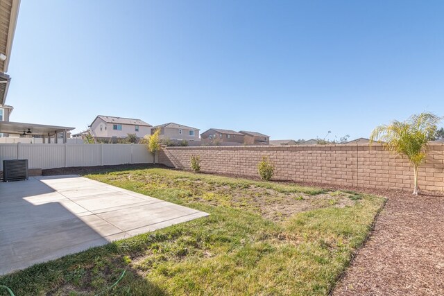 view of yard featuring a patio area and central AC