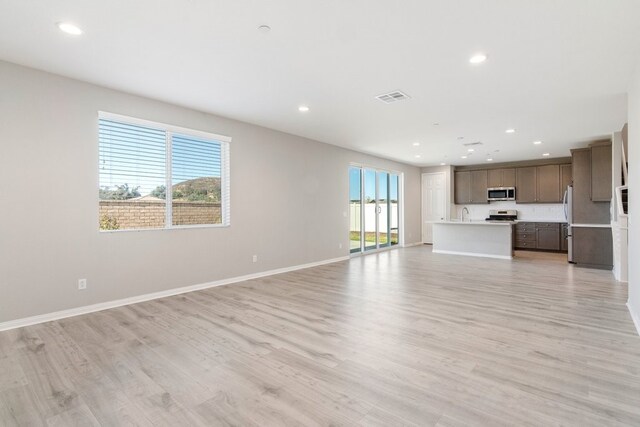 unfurnished living room with light wood-type flooring