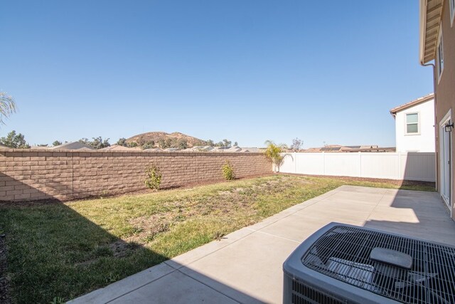 view of yard featuring central AC unit and a patio